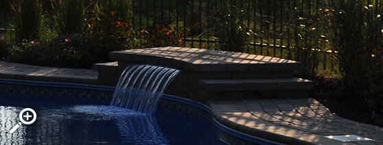 In-ground swimming pool waterfall