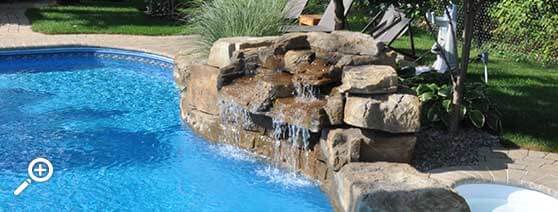 In-ground swimming pool waterfall